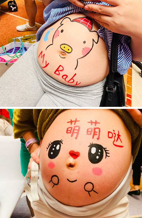 用专用的人体彩绘颜料作画,在宝妈们高高隆起的肚皮上画下了笑脸,小猪